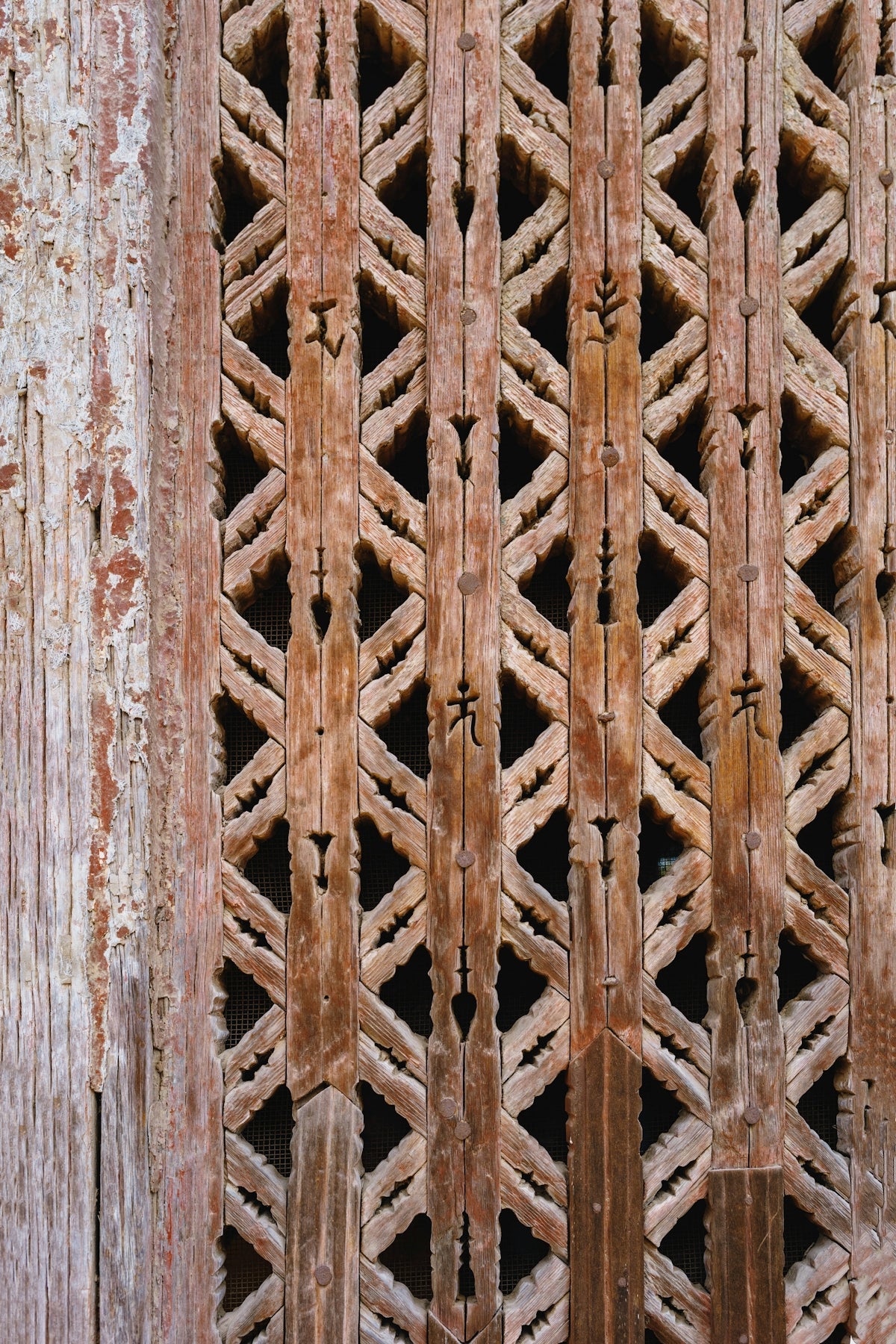 Ornate wooden lattice with weathered texture