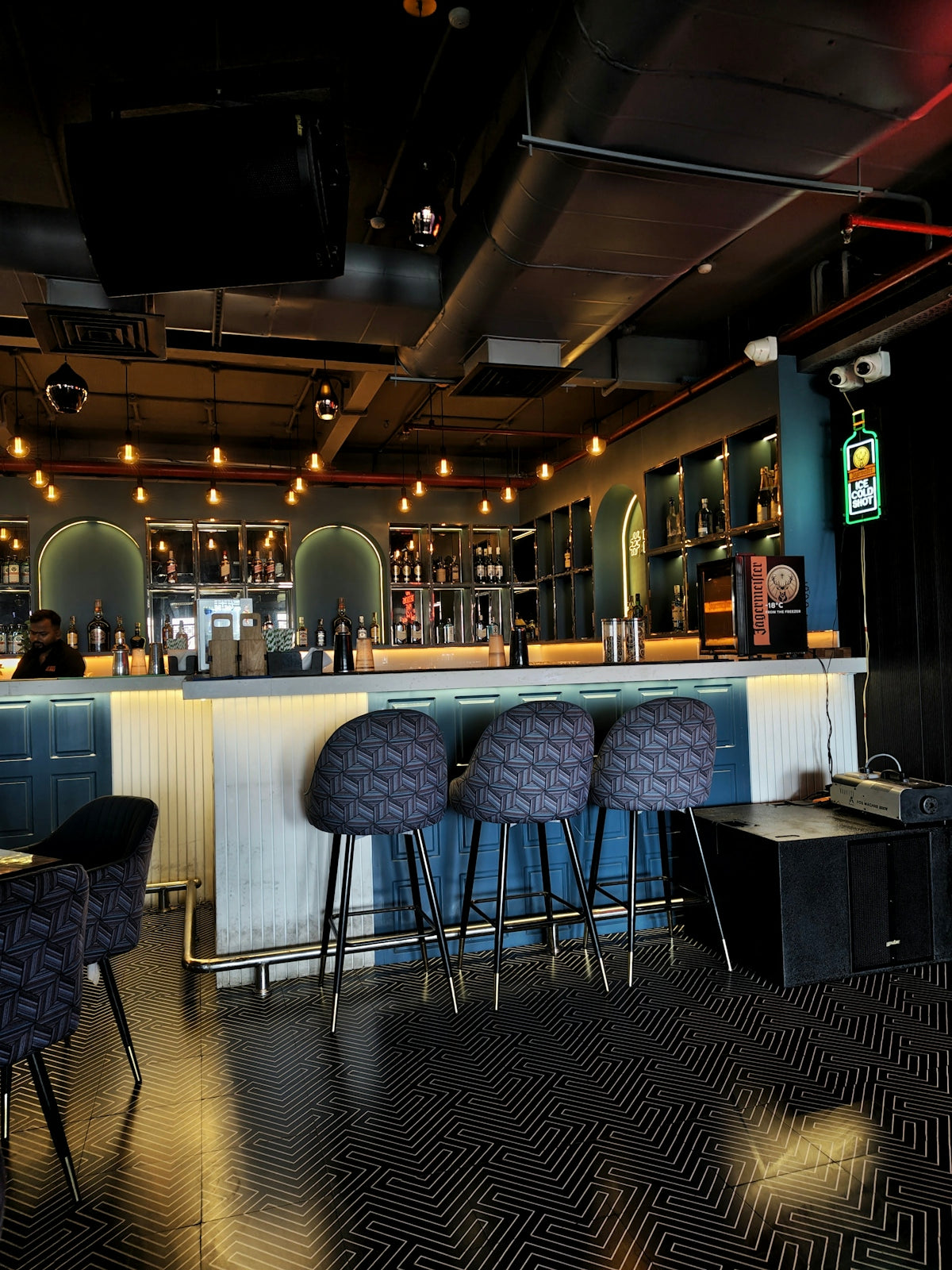 Modern bar interior with counter and stools