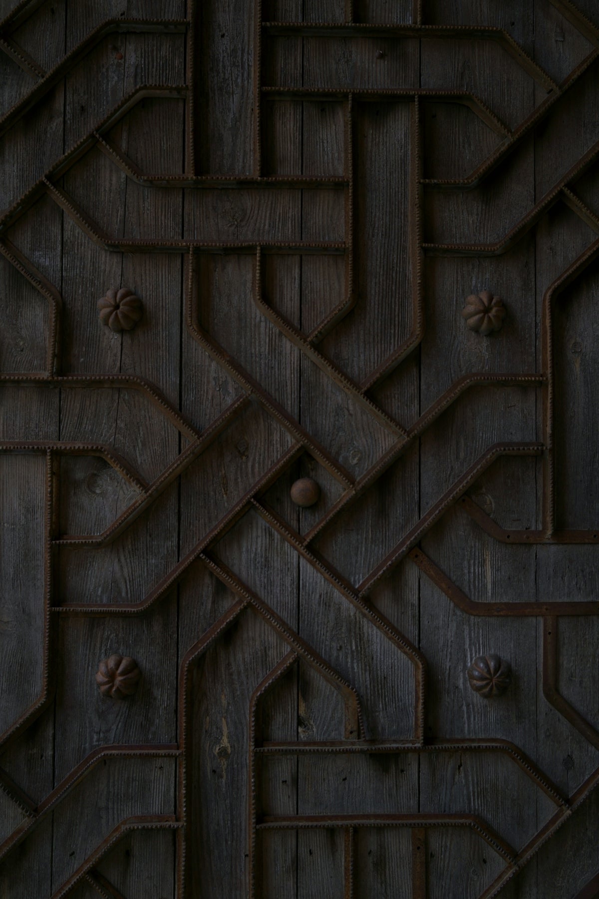 Intricate geometric pattern on a dark wooden surface.