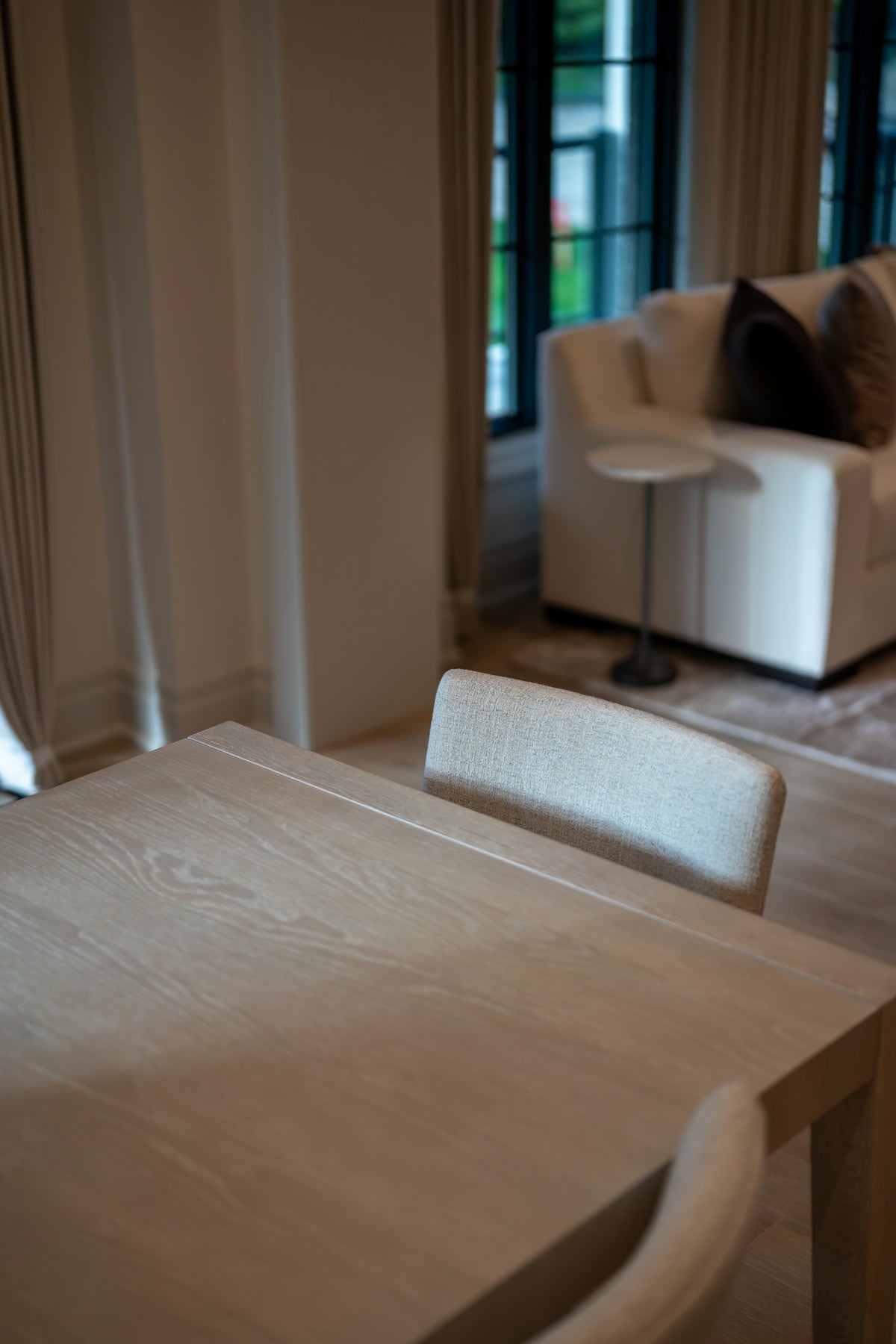 Light wooden table and chair in a modern living room.