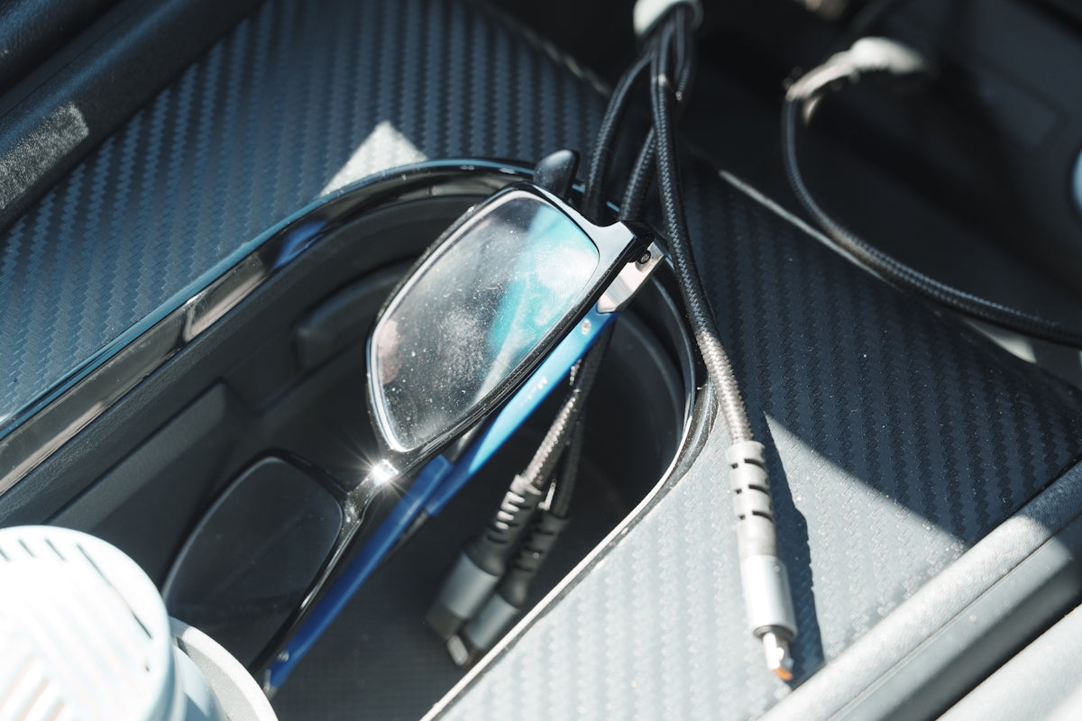 Glasses and cables in a car console.
