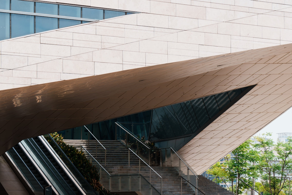 Modern building with angled architecture, escalators, and glass windows.