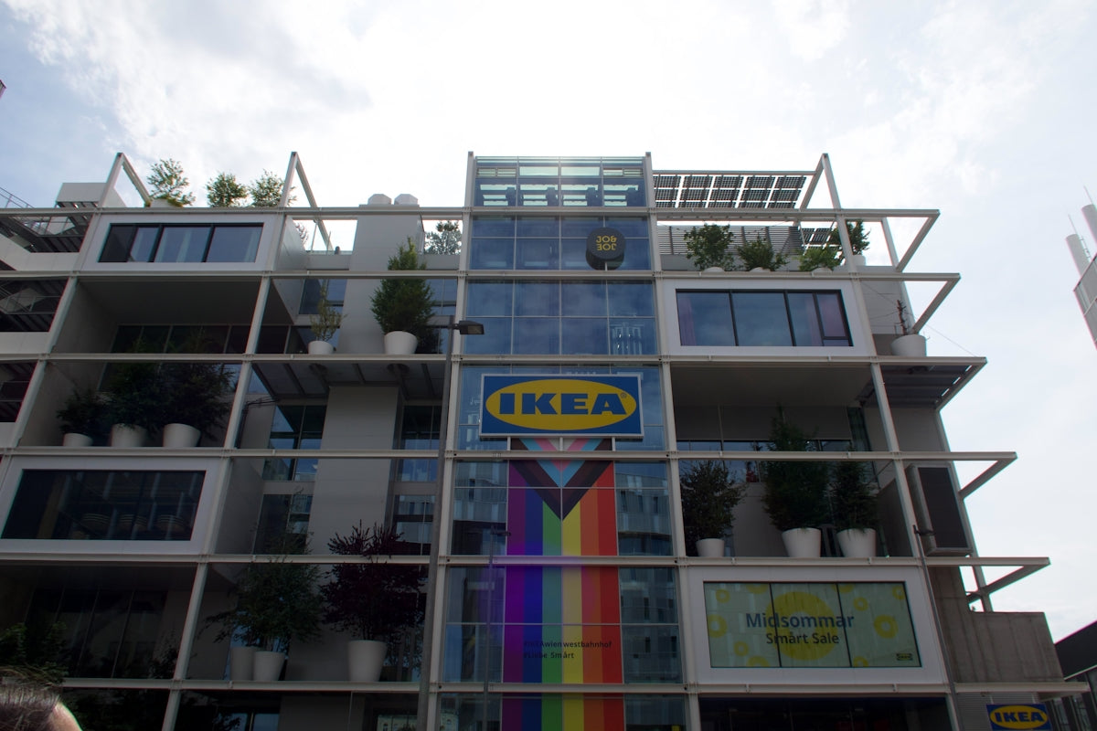 Modern ikea building with a rainbow flag display.