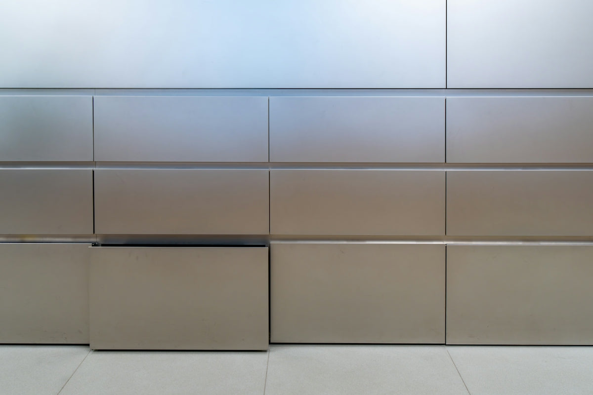 Metallic rectangular panels forming a modern wall.