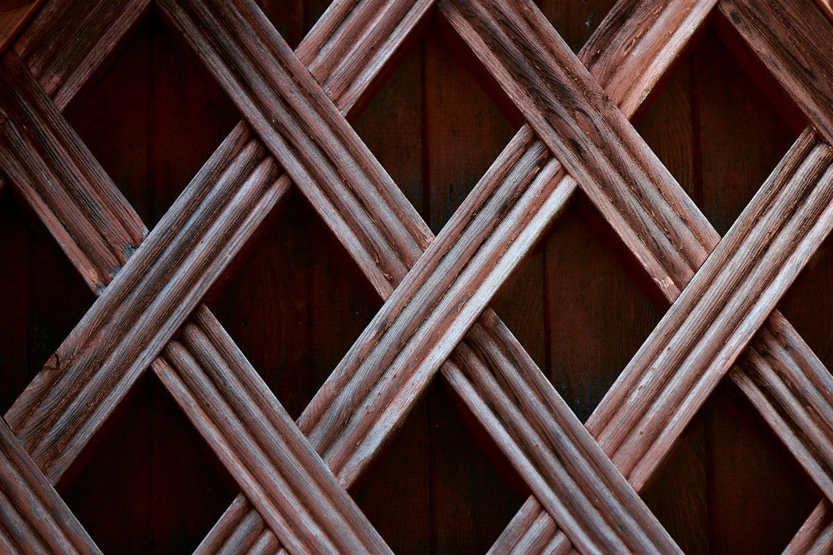 A wooden lattice pattern with diagonal strips.
